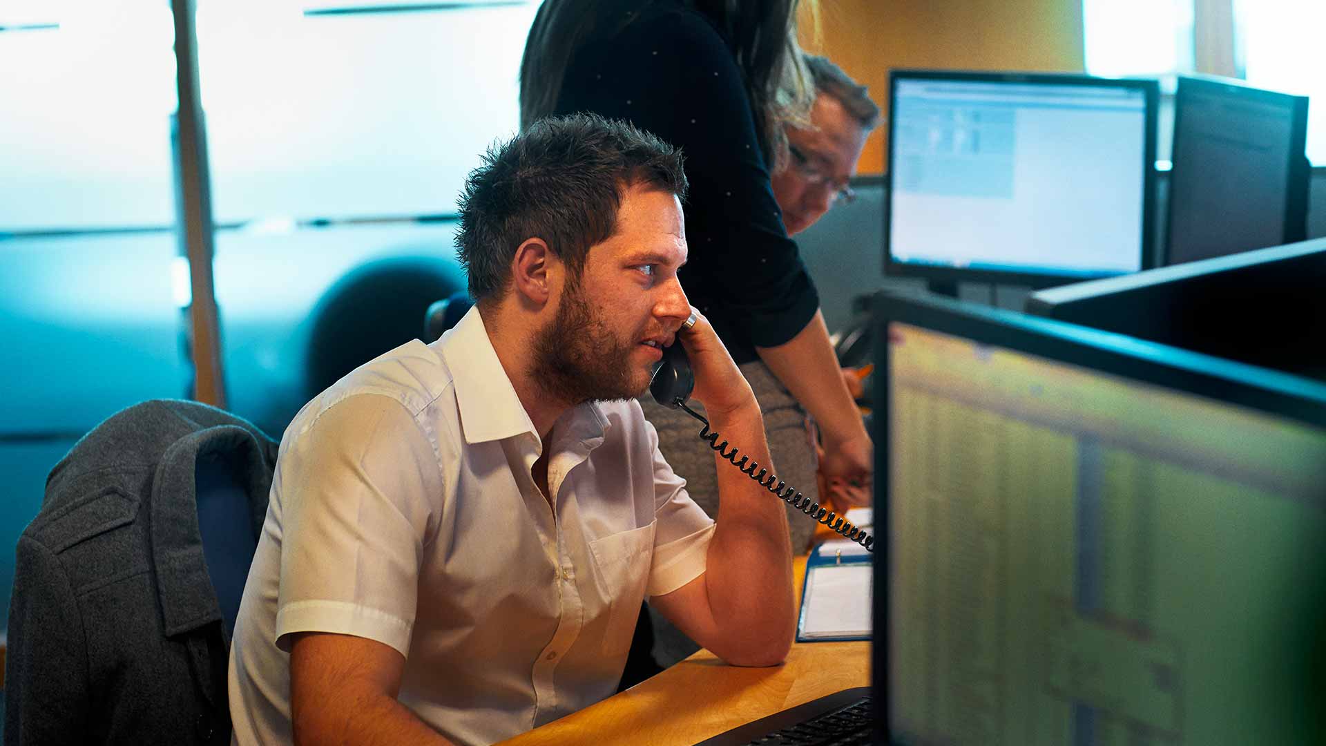 An office worker on the phone at his desk
