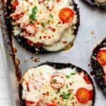 Close up shot of the portobello mushroom pizzas with the toppings after cooking with cheese melting