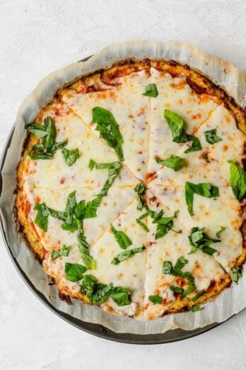 Cauliflower Pizza Crust topped with marinara, cheese and basil