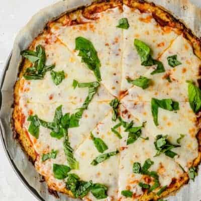 Cauliflower Pizza Crust topped with marinara, cheese and basil
