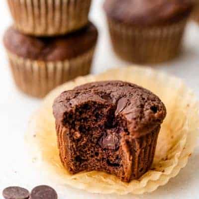Bite taken out of double chocolate chip muffin