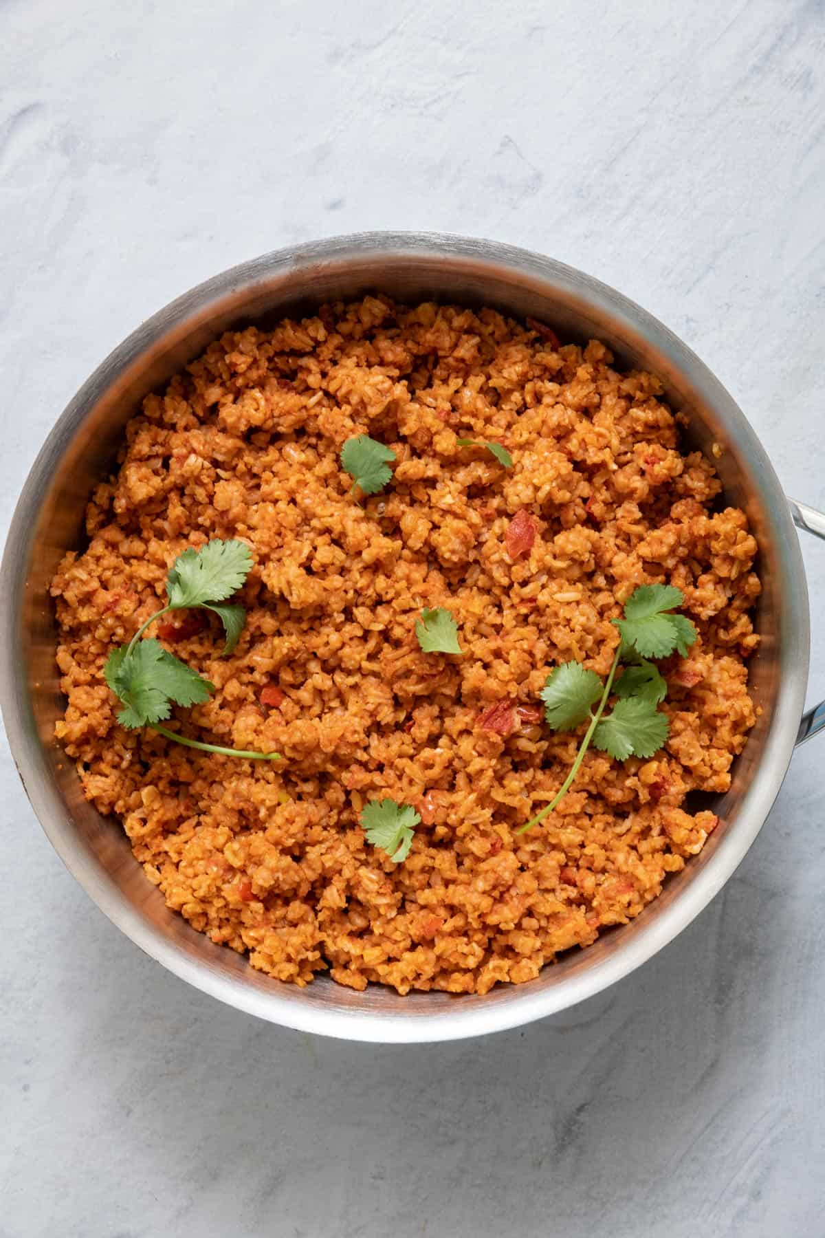 Final cooked tomato rice in large pot garnished with fresh cilantro