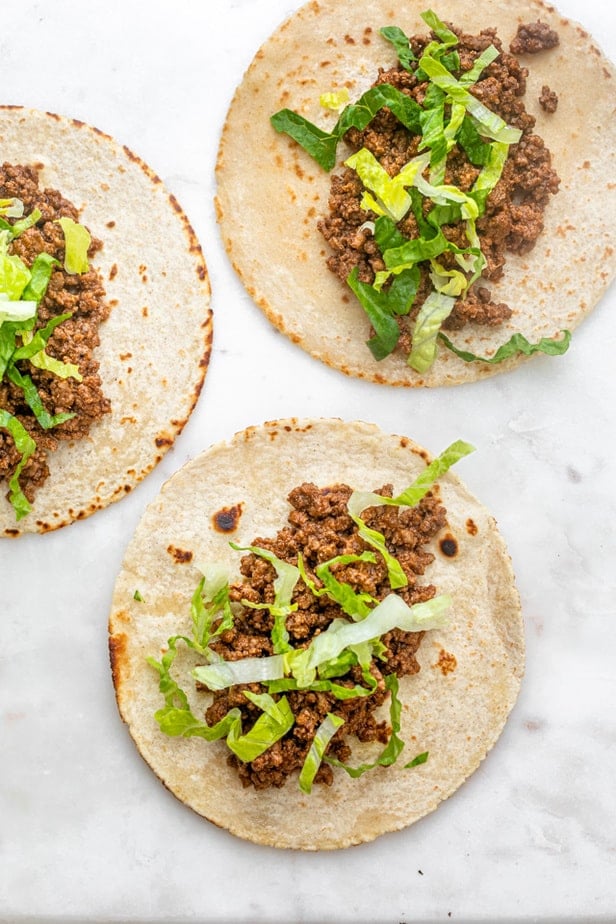 Starting to assemble the tacos with lettuce