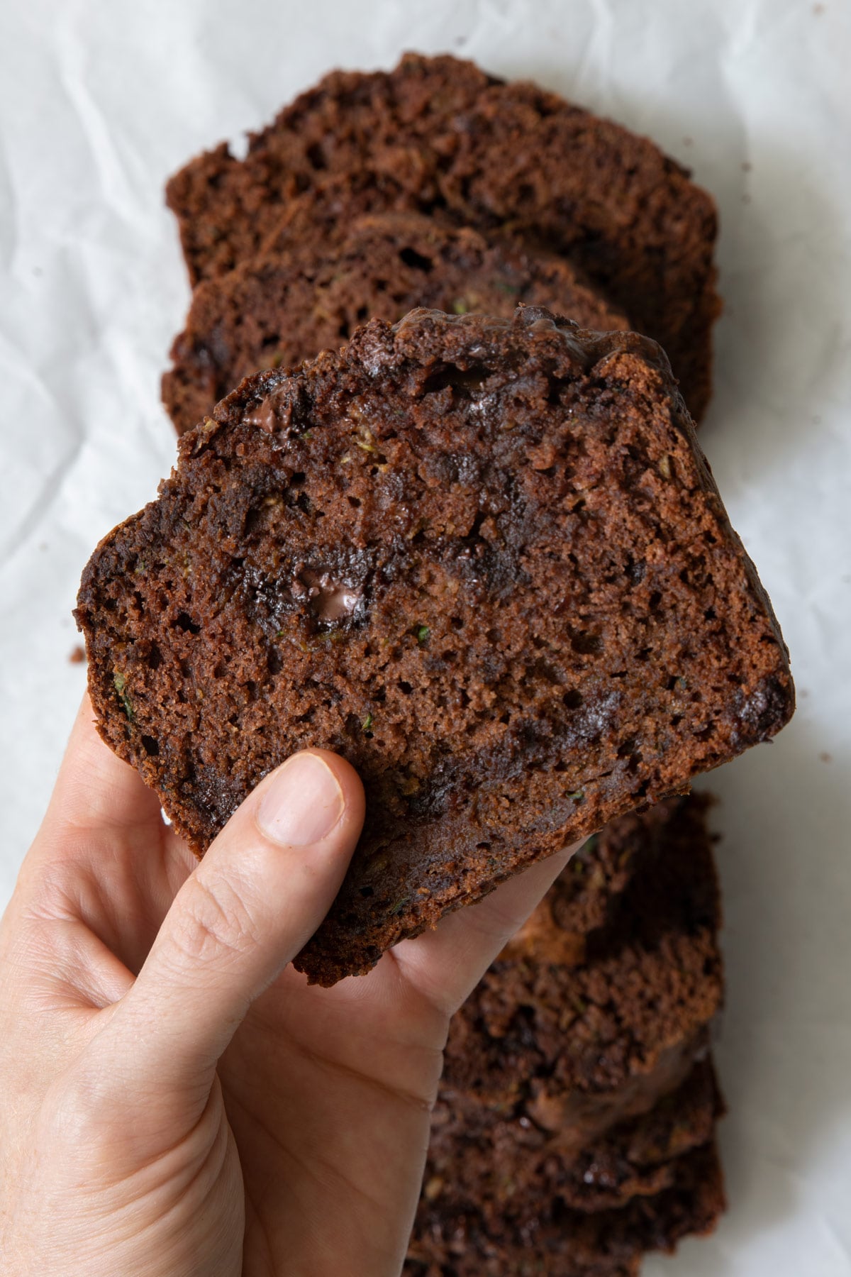Overhead shot of hand holding a slice showing texture.