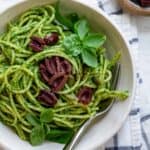Pumpkin seed pesto pasta topped with kalamata olives
