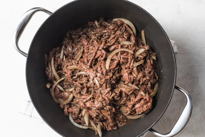 Beef shawarma placed in a large pot ready to be cooked