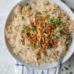 Plate served of Lebanese Rice topped with pine nuts, almonds and parsley