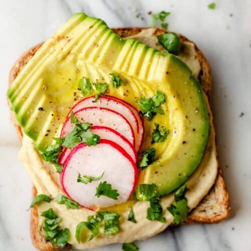 Hummus toast made with avocados, radishes and cilantro