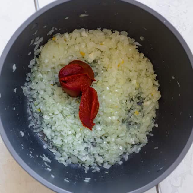 Tomato paste added to the onions.