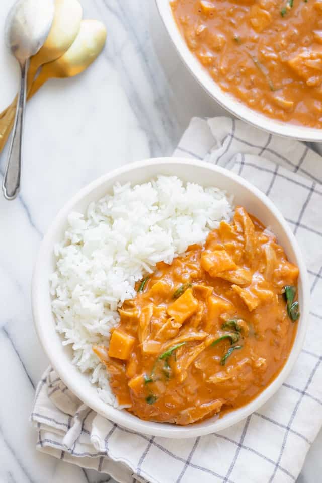 Bowl of white rice with peanut soup over the rice