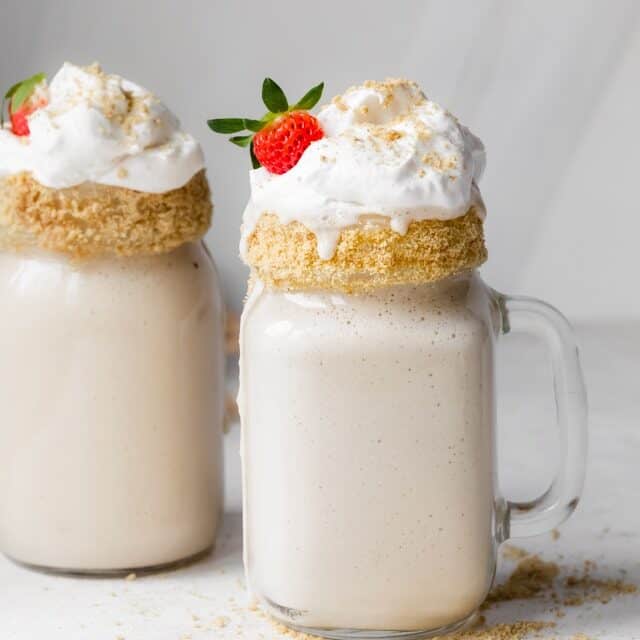 Final tahini milkshake recipe with cool whip, and strawberries and cookie frosted glasses