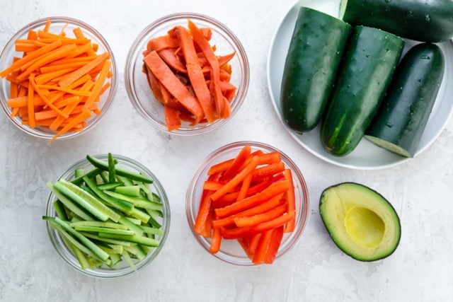Ingredients to make the recipe: cucumbers, smoked salmon, carrots, red peppers and avocado