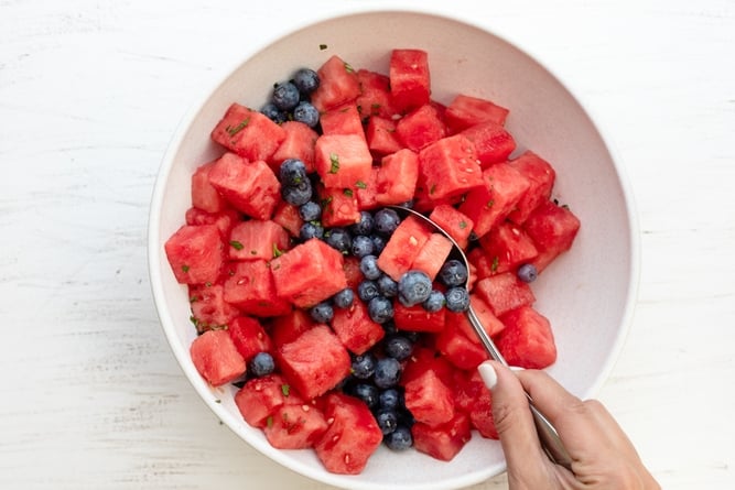 Mixing the watermelon and blueberries with the mint, honey and lemon juice