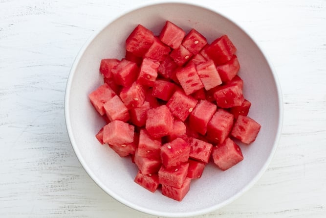 Large white bowl of cubed watermelon pieces