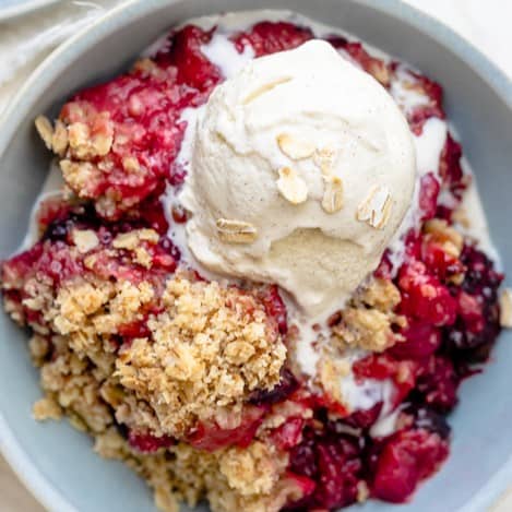 Crisp in a bowl topped with vanilla icecream,