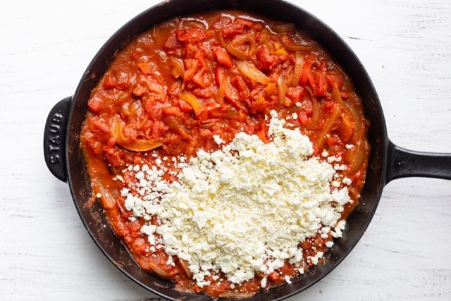 Added feta cheese to the skillet with the spiced tomato sauce