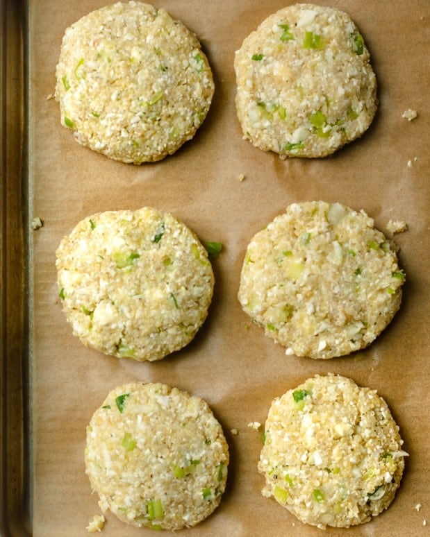 Shaped fritters on a baking sheet.