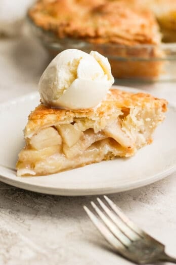 Slice of easy apple pie served a la mode with ice cream on top