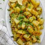 Lebanese Spicy Potatoes, also know as Batata Harra served with fresh cilantro and lemon wedges