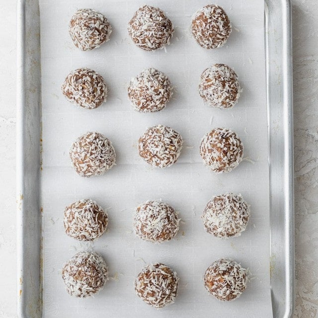 Coconut date balls with coconut on them.