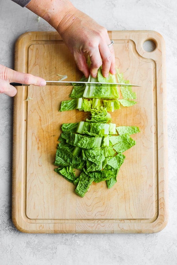 overhead shot of knife chopping up romaine lettuce