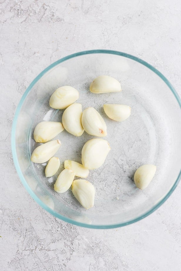 peeled garlic in a glass bowl