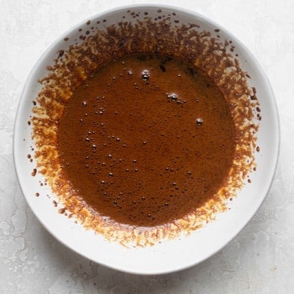 After stirring the coffee, slowly making it thicker.