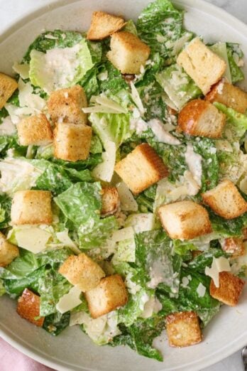 Caesar salad with croutons in a bowl.