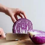 Tutorial for how to cut cabbage, showing cabbage sliced in half