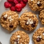 Banana oatmeal cups on a dish with raspberries.