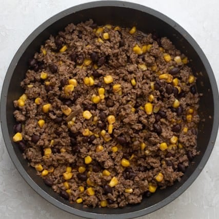 All of the nacho mixture ingredients combined in the skillet.