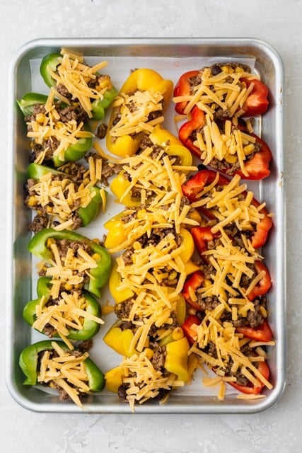Shredded cheese added on top of the bell peppers.