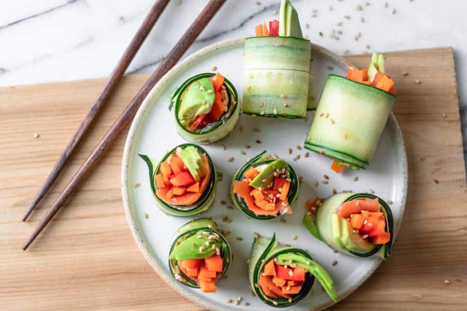 Cucumber roll sushi on a serving dish with chopsticks.