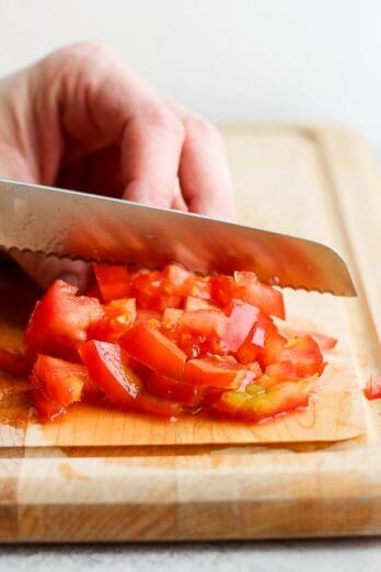 Diced tomatoes on a cutting board.