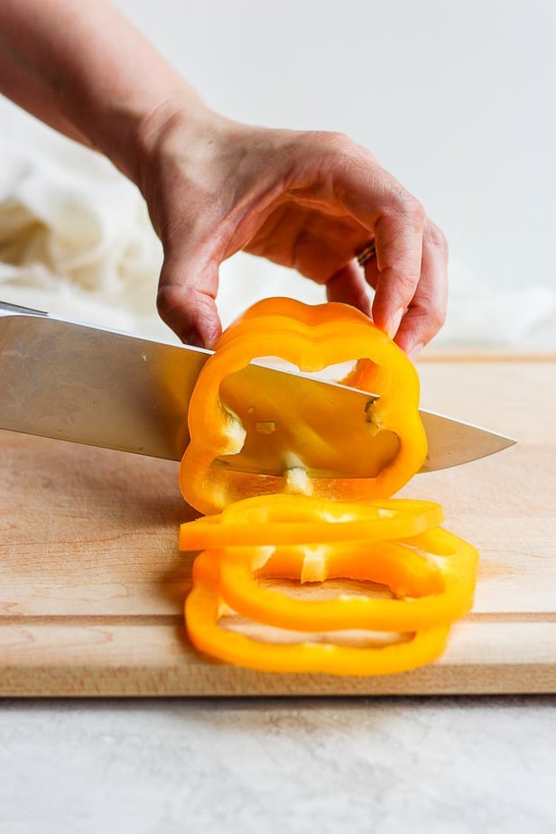 knife cutting a bell pepper into slices