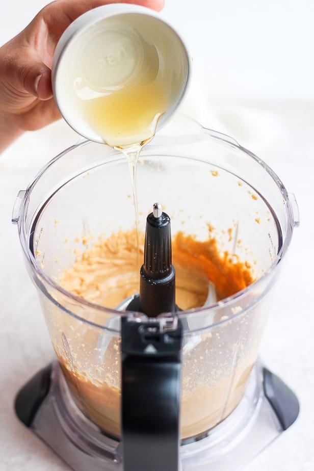 honey being poured into a blender