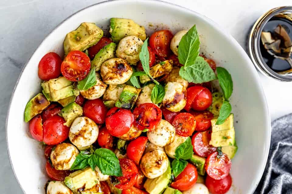 Avocado Caprese salad in a bowl.