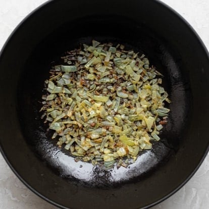 Onions cooked in a pan.
