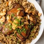 Freekah with chicken on a serving dish.