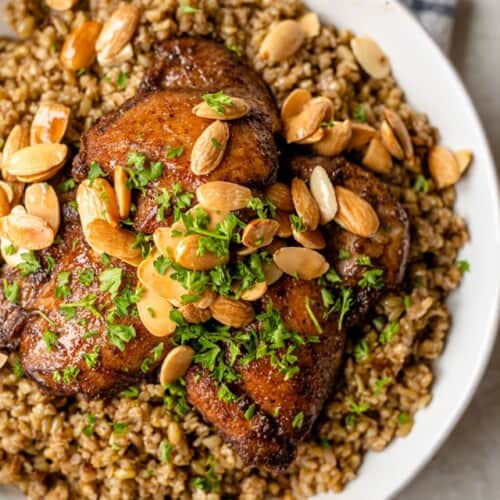 Freekah with chicken on a serving dish.