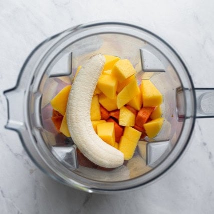 Smoothie ingredients in a blender before blending.