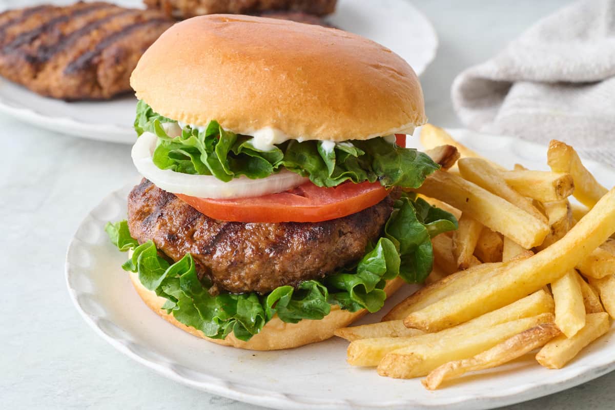 Ground beef grilled burger with fries.