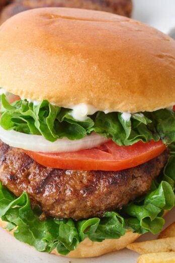 Homemade hamburger on a bun with toppings.
