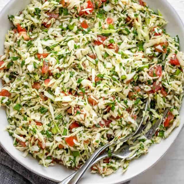 Large bowl of Lebanese cabbage salad with tomatoes and cilantro