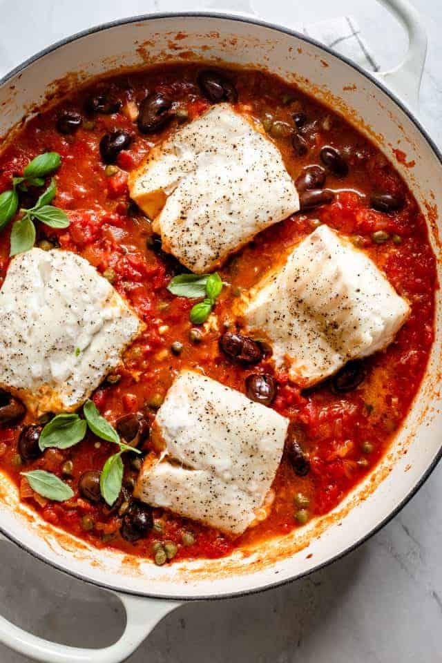 Tomato poached fish using cod along with olives an capers