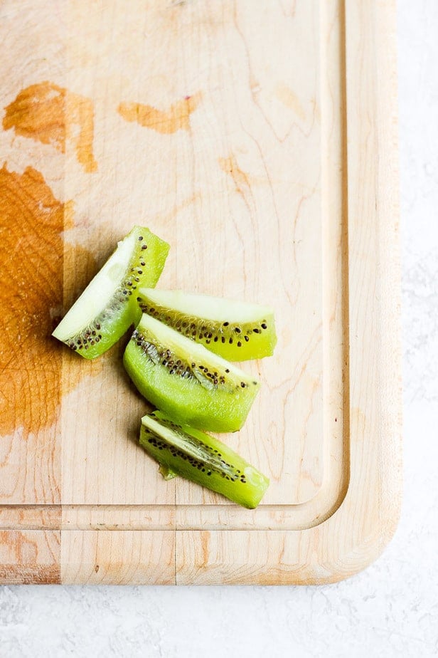 Wedges of kiwi on a cutting board