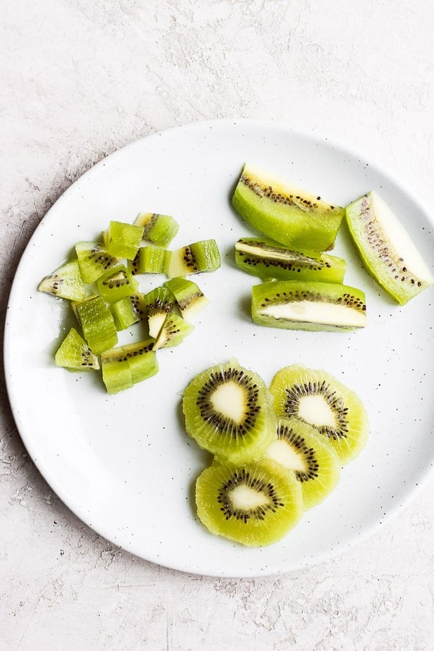 Kiwi cut three ways on a plate