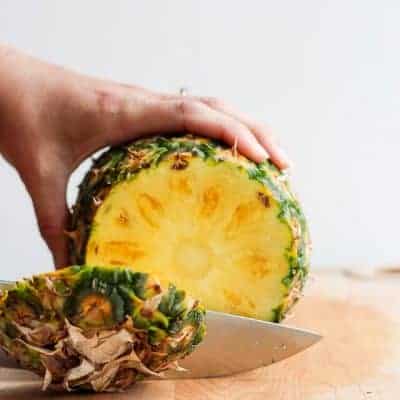Trimming the end off a pineapple