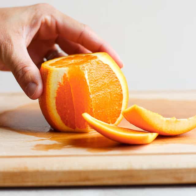 Orange on cutting board with peel removed
