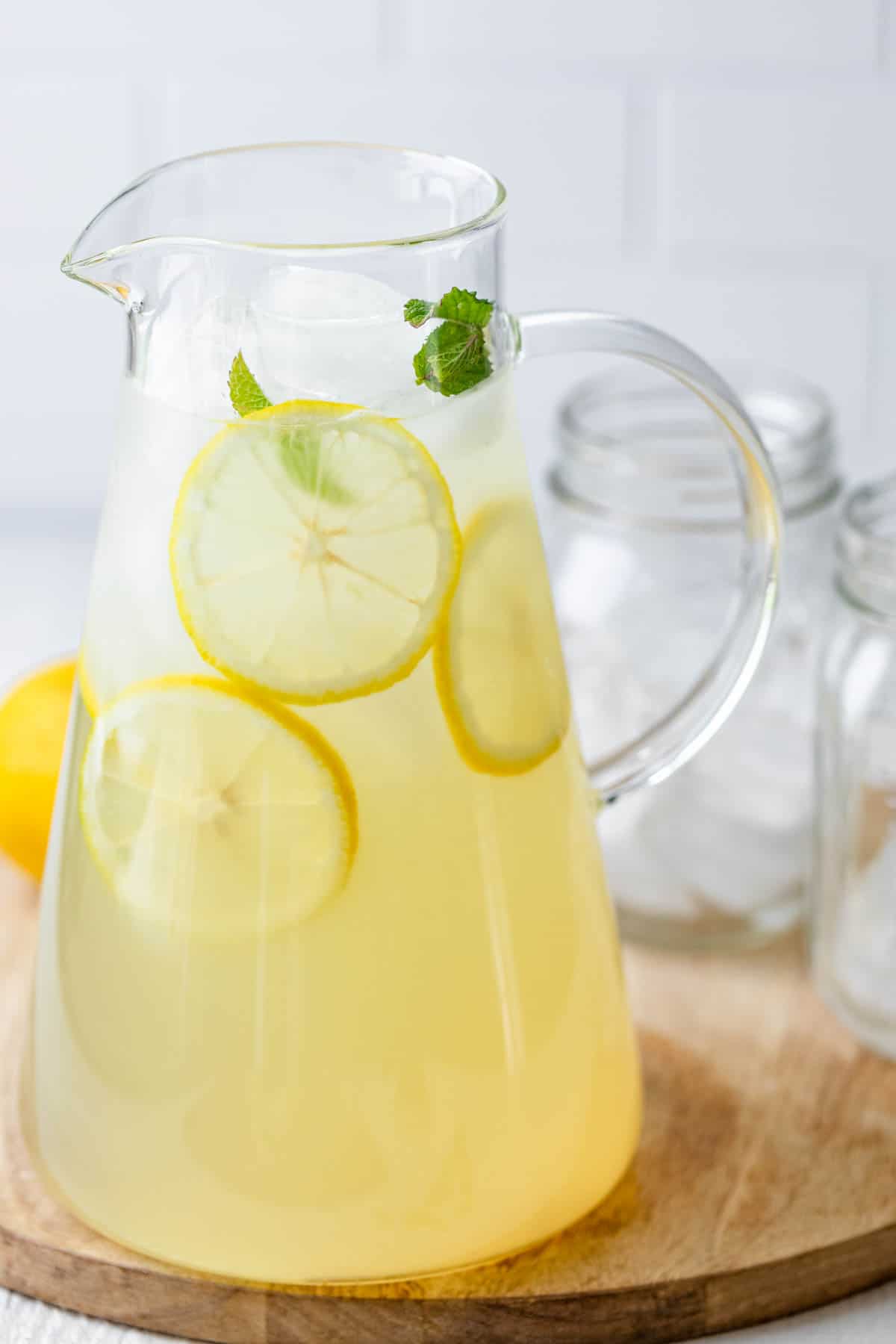 Clear jug of lemonade with fresh slices of lemons
